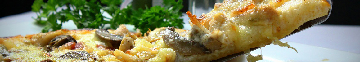 Eating Pizza at Adam's Pizza & Convenience.